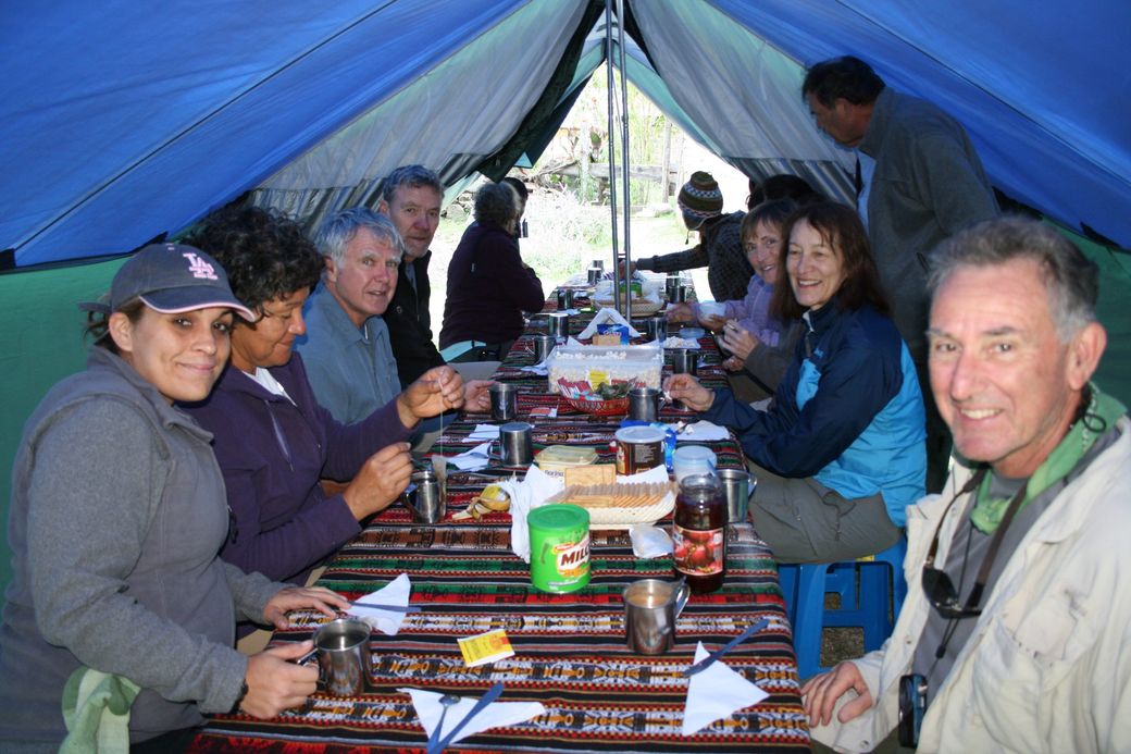 The group at the table in the dining tent
